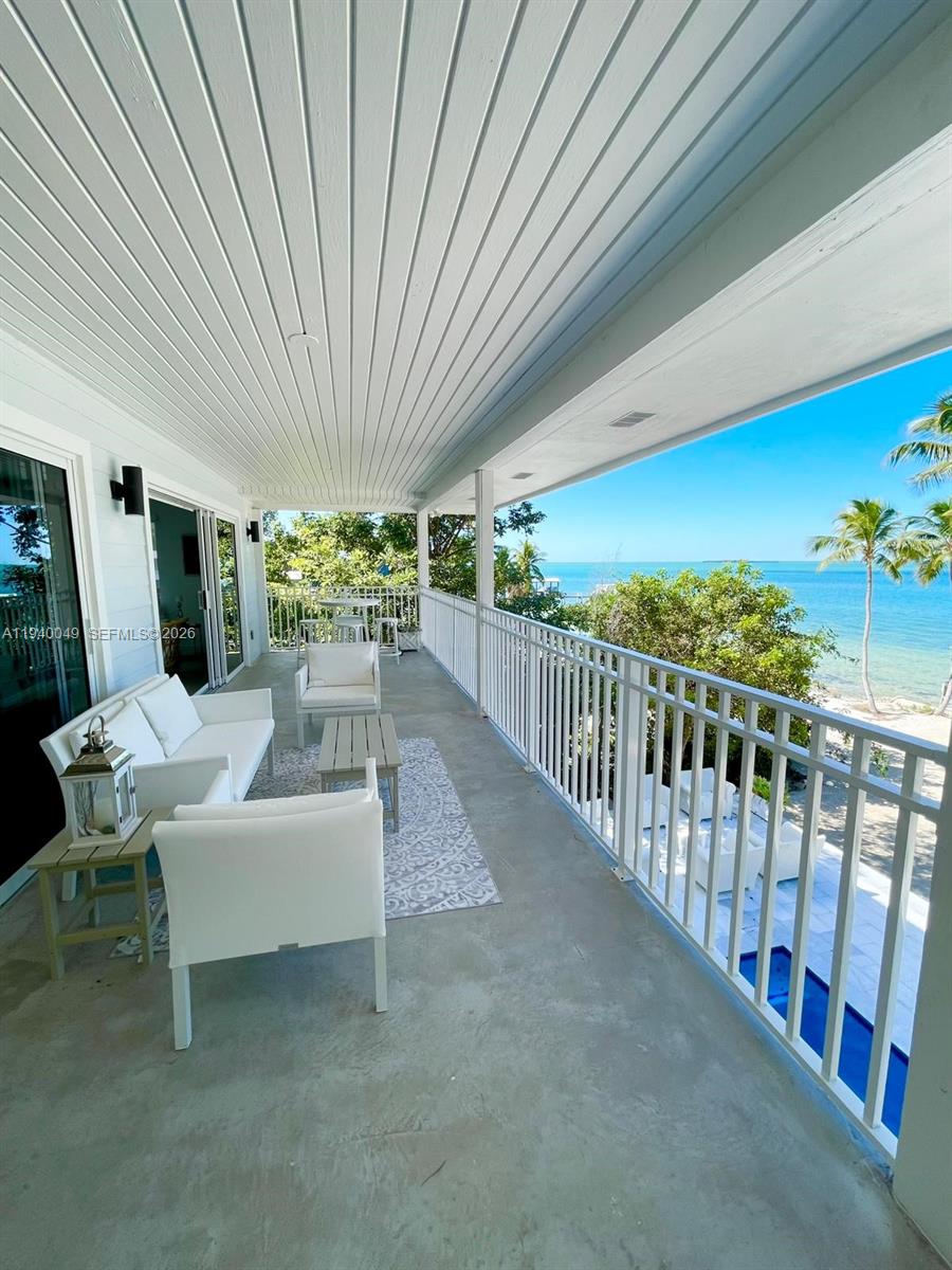 96180 Overseas Highway, Unit 1 Key Largo, FL 33037 - Photo 35 of 83 a view of a patio with a table and chairs