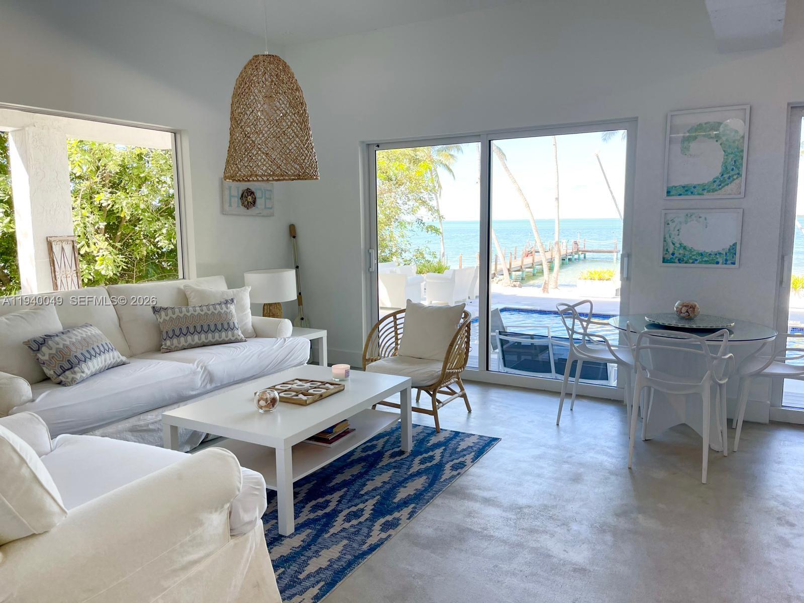 96180 Overseas Highway, Unit 1 Key Largo, FL 33037 - Photo 45 of 83 a living room with furniture and a window