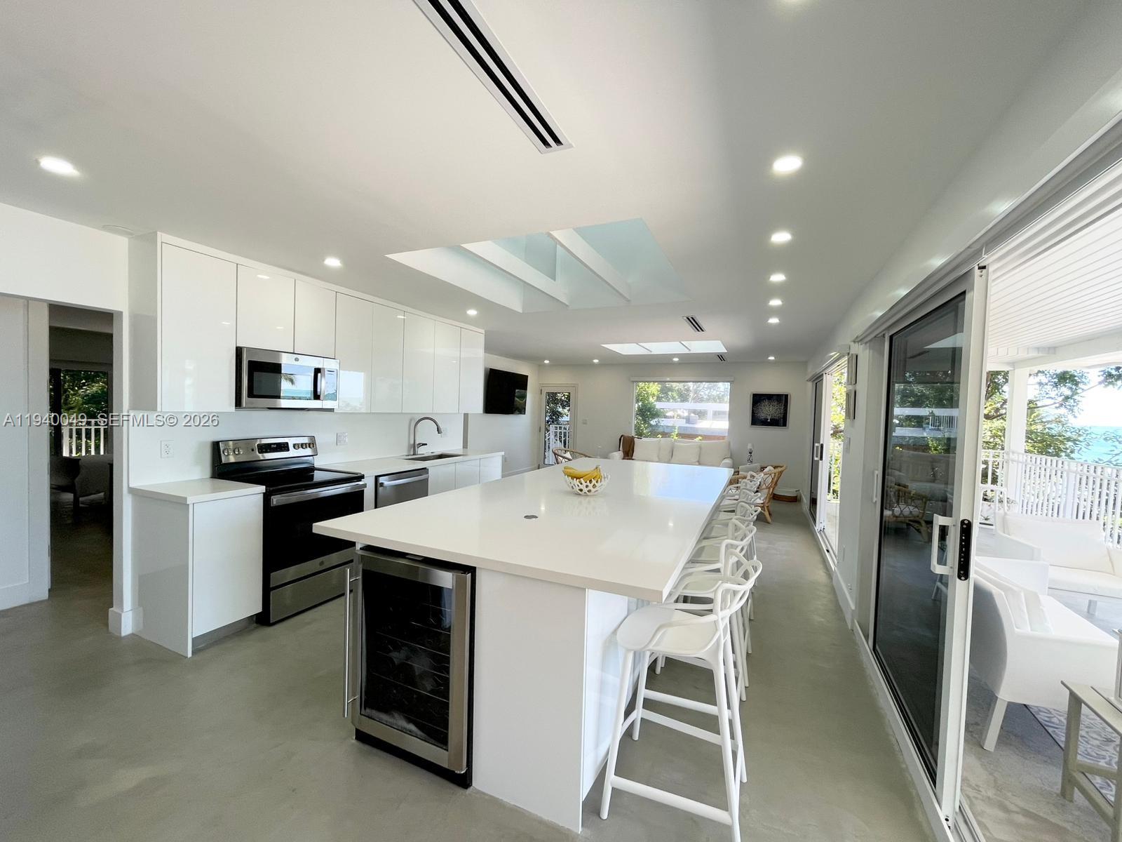 96180 Overseas Highway, Unit 1 Key Largo, FL 33037 - Photo 47 of 83 a large kitchen with a table and chairs