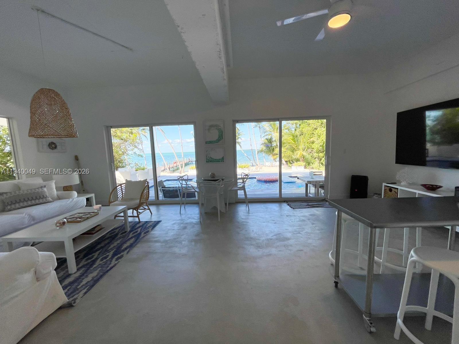 96180 Overseas Highway, Unit 1 Key Largo, FL 33037 - Photo 48 of 83 a living room with furniture and a flat screen tv