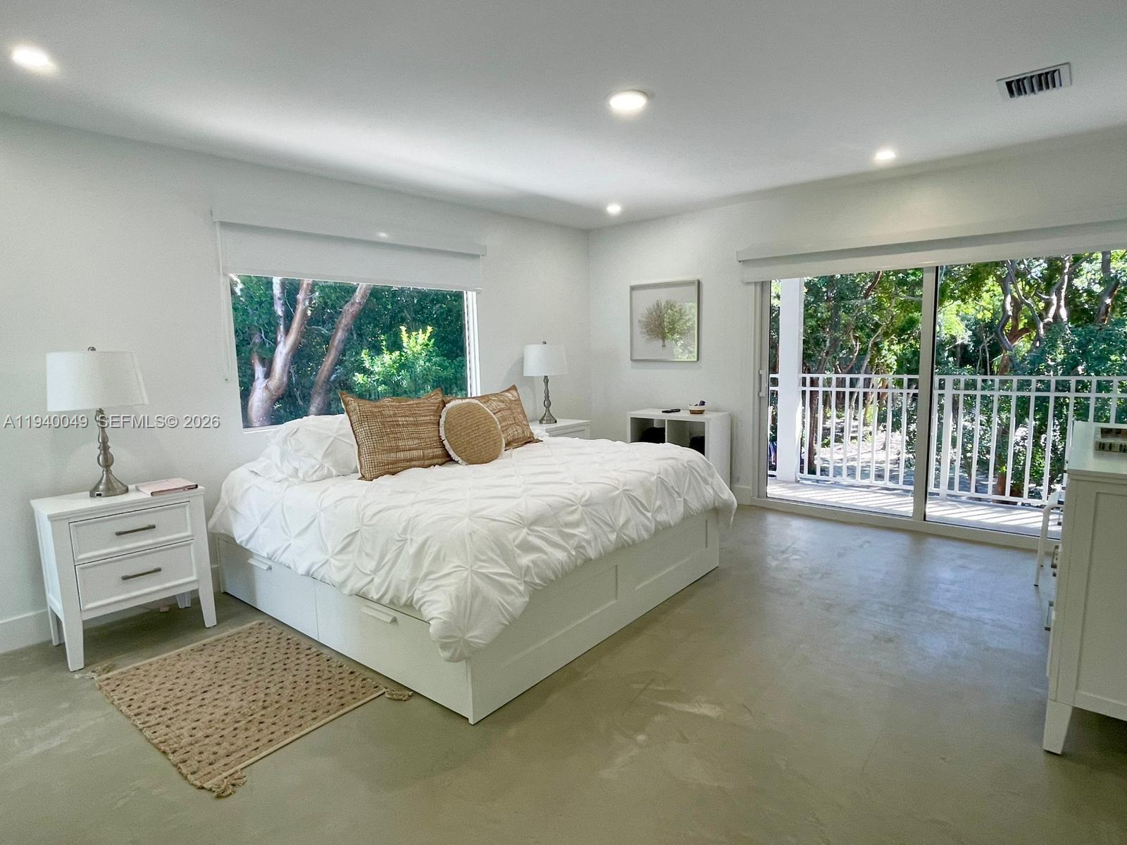 96180 Overseas Highway, Unit 1 Key Largo, FL 33037 - Photo 53 of 83 a bedroom with a bed and a large window