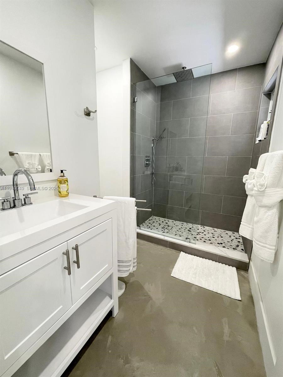 96180 Overseas Highway, Unit 1 Key Largo, FL 33037 - Photo 56 of 83 a bathroom with a sink a toilet and shower