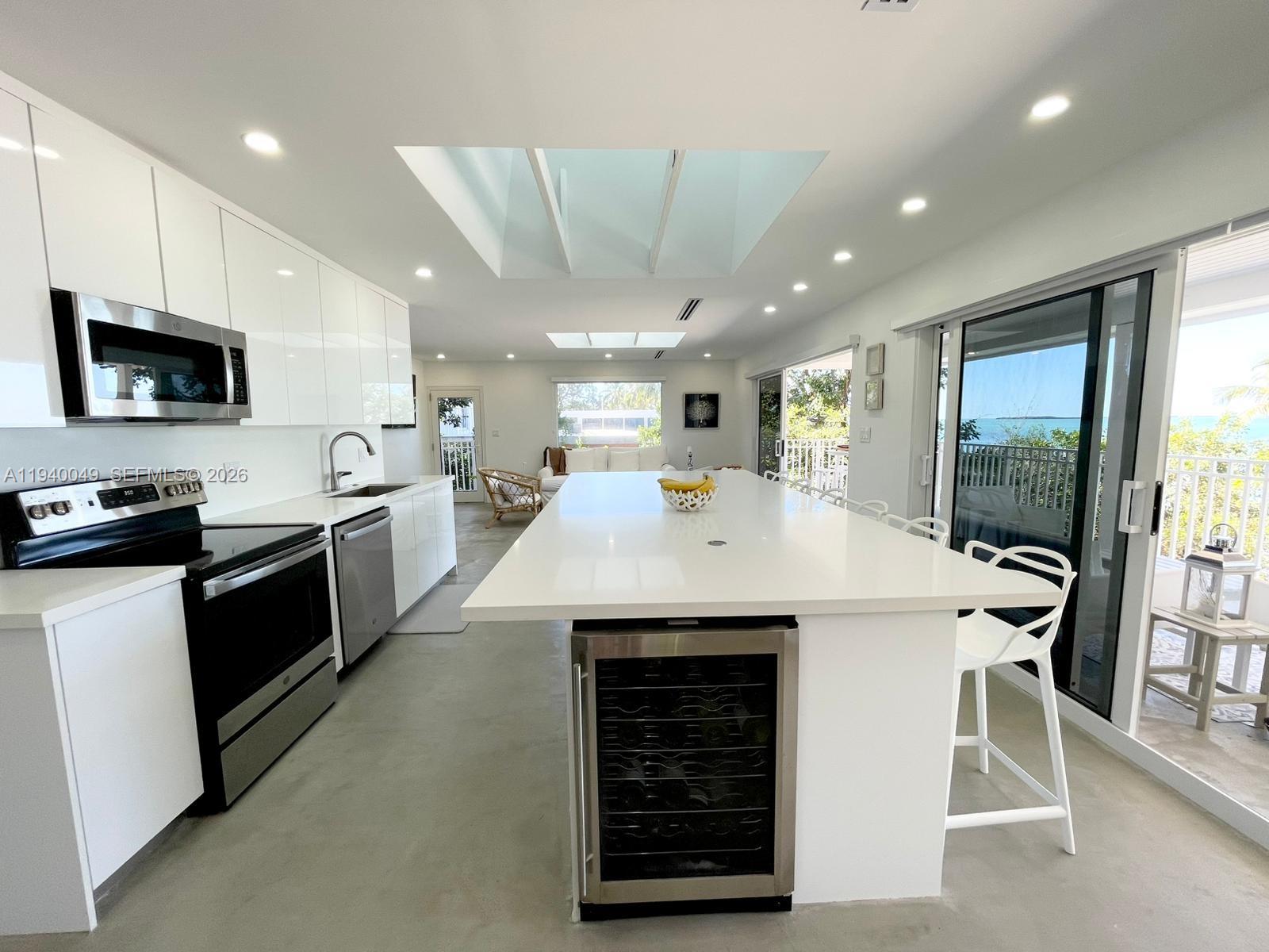96180 Overseas Highway, Unit 1 Key Largo, FL 33037 - Photo 59 of 83 a kitchen with a sink stainless steel appliances a counter top space cabinets and a window