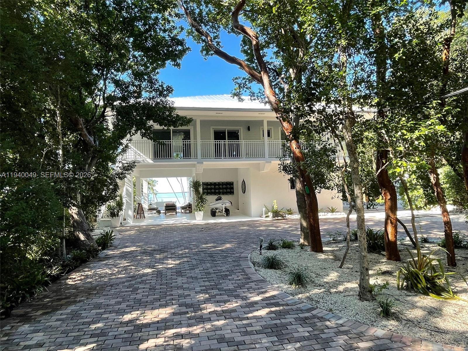 96180 Overseas Highway, Unit 1 Key Largo, FL 33037 - Photo 70 of 83 a front view of a house with a garden