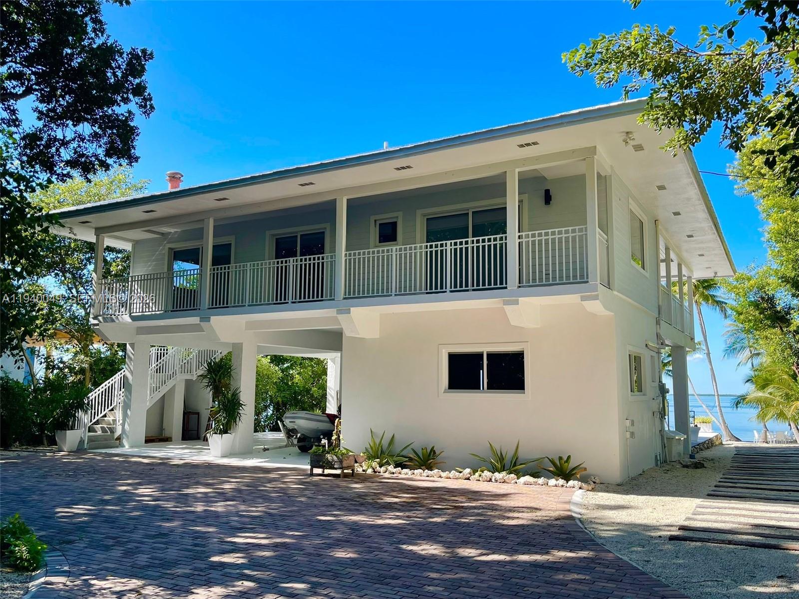 96180 Overseas Highway, Unit 1 Key Largo, FL 33037 - Photo 72 of 83 a front view of a house with a yard