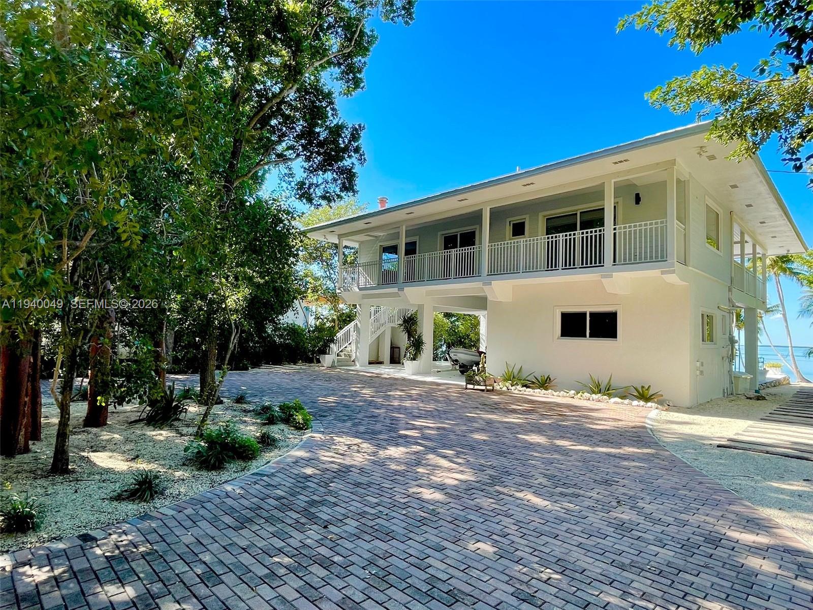 96180 Overseas Highway, Unit 1 Key Largo, FL 33037 - Photo 78 of 83 a front view of a house with a garden