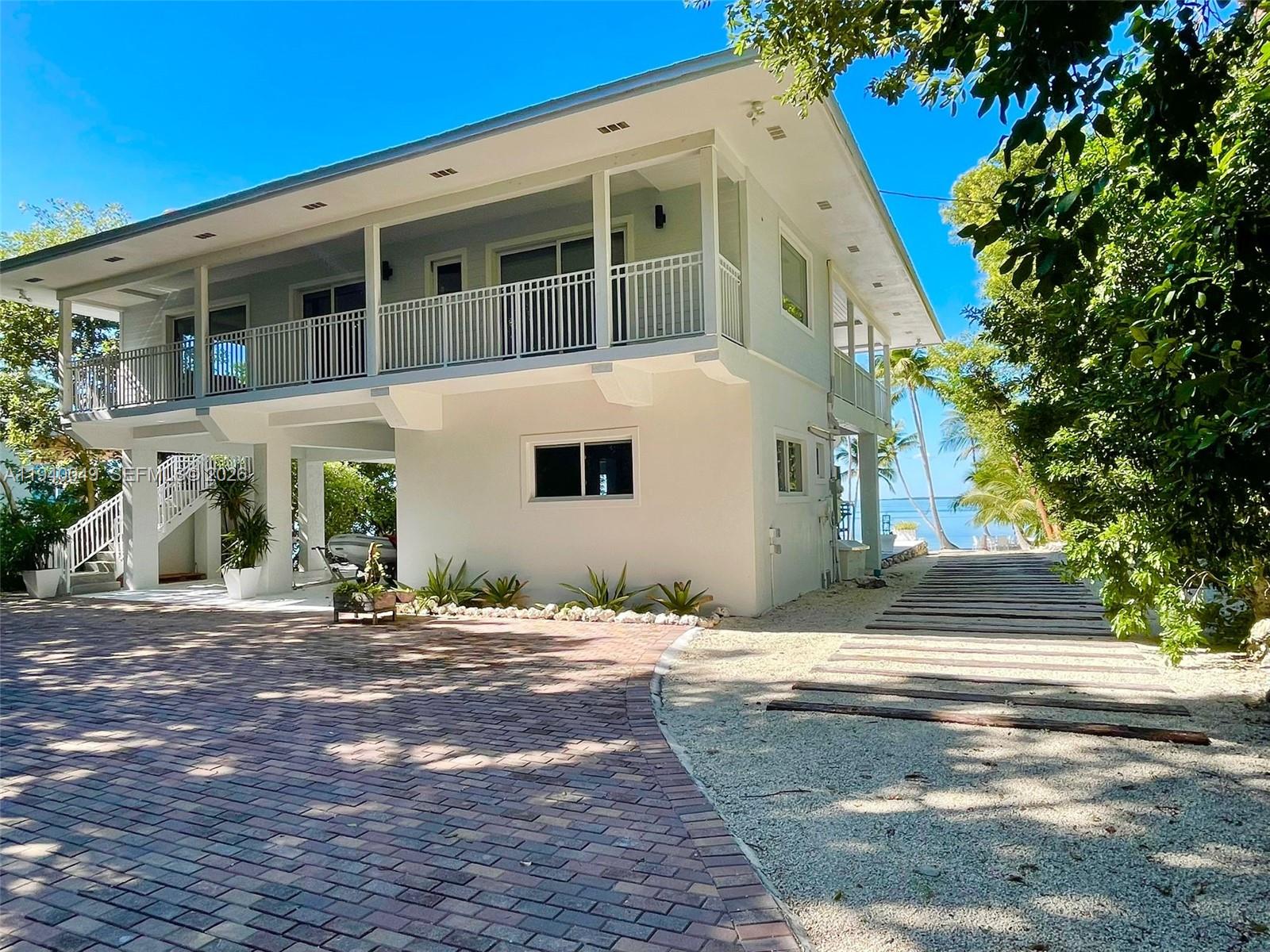 96180 Overseas Highway, Unit 1 Key Largo, FL 33037 - Photo 81 of 83 a view of a house with a yard