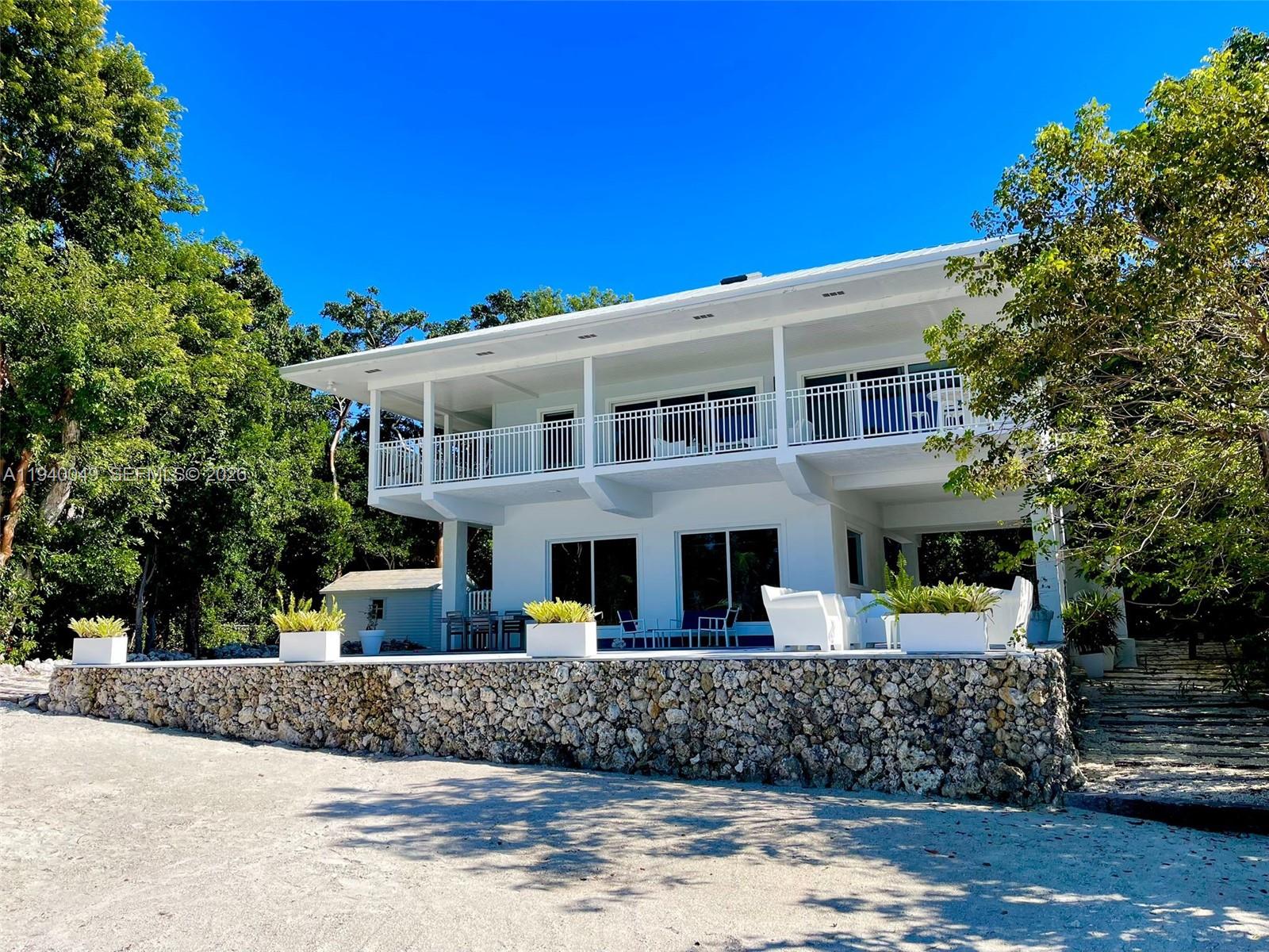 96180 Overseas Highway, Unit 1 Key Largo, FL 33037 - Photo 82 of 83 a front view of a building with a garden