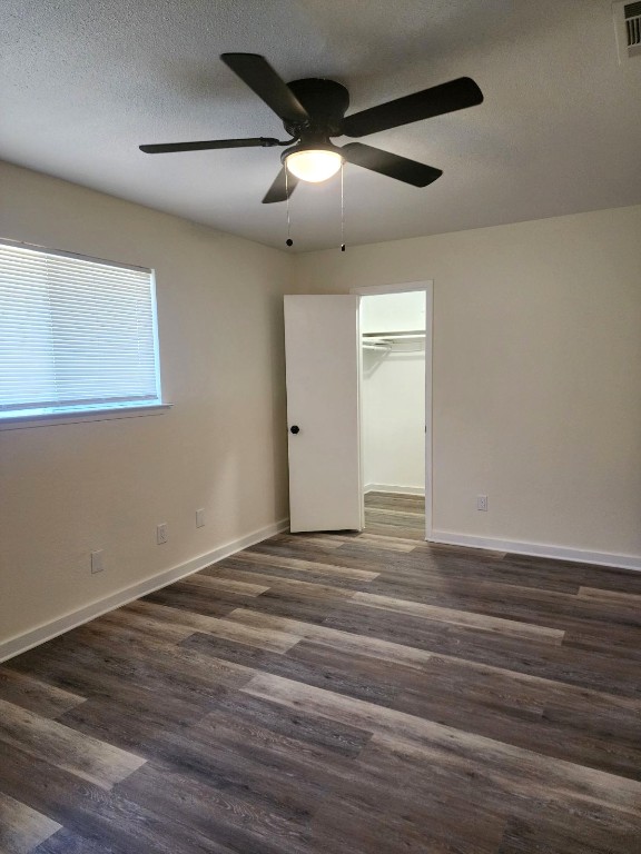 6905 Argonne Forest Cove, Unit A Austin, TX 78759 - Photo 13 of 18 an empty room with wooden floor and windows