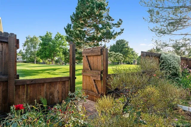 a backyard of a house with lots of green space and fountain