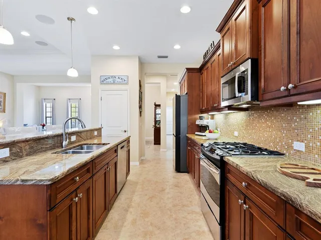 a living room with furniture and kitchen view