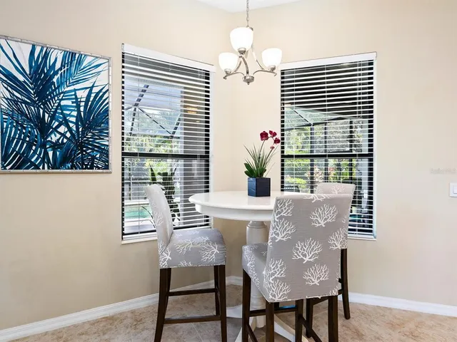 a view of a living room and dining room with wooden floor