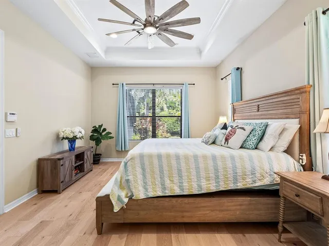 a bedroom with bed and a flat screen tv
