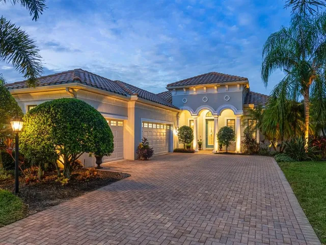 a view of a white house with a yard