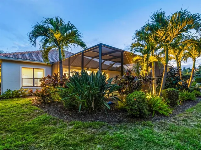 a outdoor space with patio the couches and pool with table and chairs under an umbrella