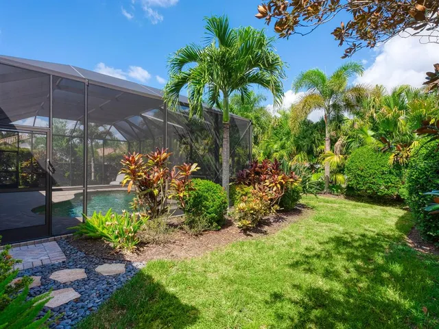 a view of a swimming pool with a table chairs under an umbrella
