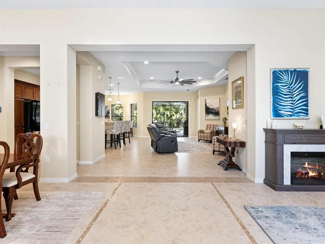 a view of a dining room with furniture and chandelier
