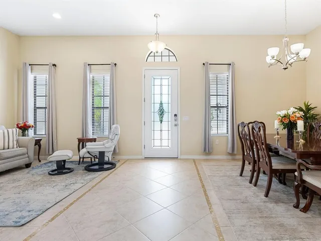 a view of a dining room with furniture and chandelier