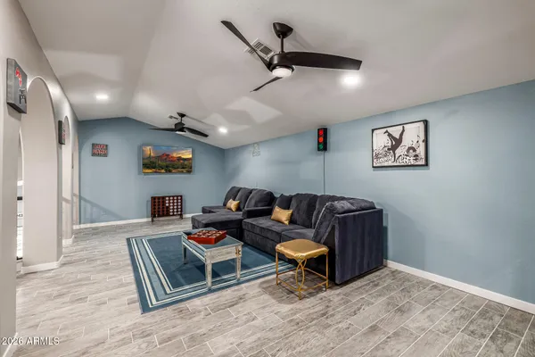 a bedroom with a large bed and a flat tv screen on dresser