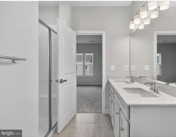 a bathroom with a double vanity sink and a mirror