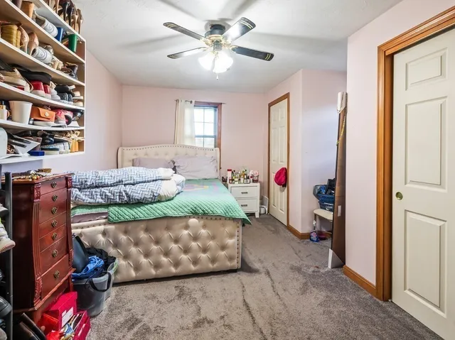 a bedroom with bed and a book shelf