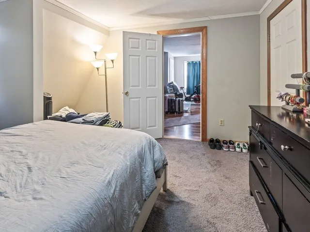 a spacious bedroom with a bed and a dresser