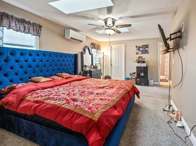 a bed sitting in a bedroom and chandelier