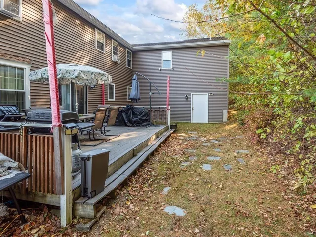 a view of a house with backyard and sitting area
