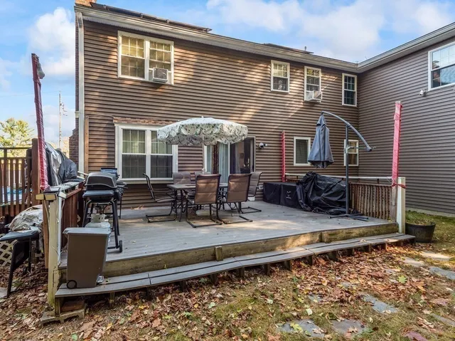 a view of a house with backyard and sitting area