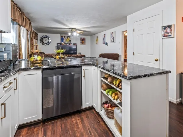 a kitchen with stainless steel appliances granite countertop a sink and cabinets