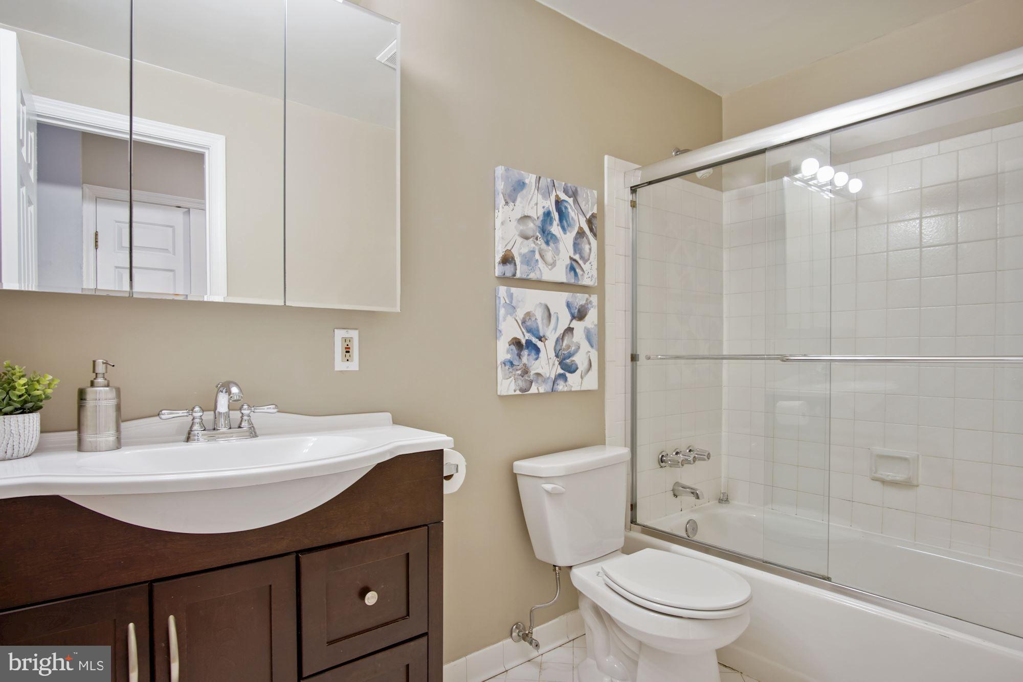 2145 California Street Northwest, Unit 201 Washington, DC 20008 - Photo 20 of 30 Bath with glass shower doors, deluxe vanity