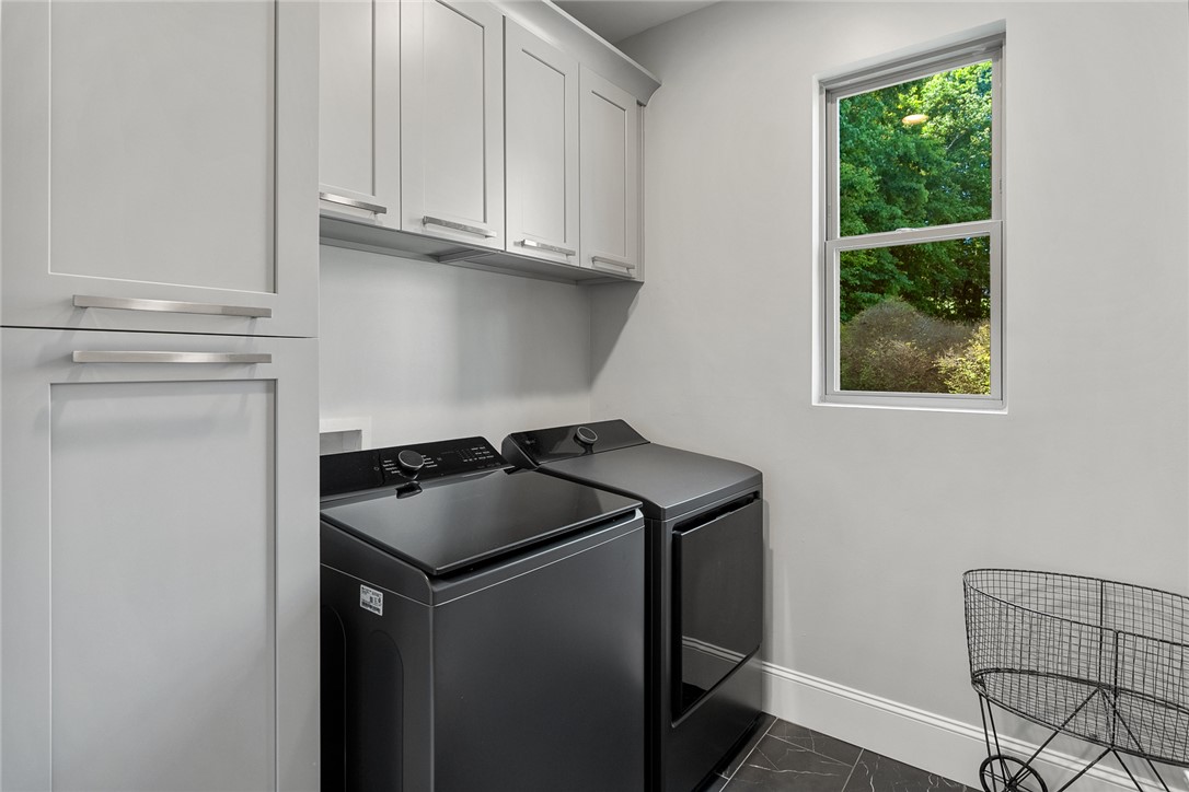 140 Turnberry Road Anderson, SC 29621 - Photo 19 of 44 This dedicated laundry area offers ample storage and essential appliances for efficient household tasks.