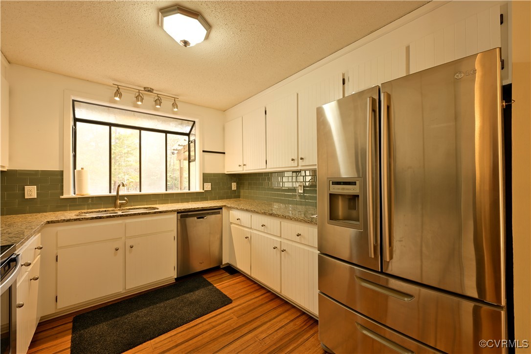 6610 Glebe Point Road Chesterfield, VA 23838 - Photo 13 of 36 a kitchen with stainless steel appliances a refrigerator sink and cabinets