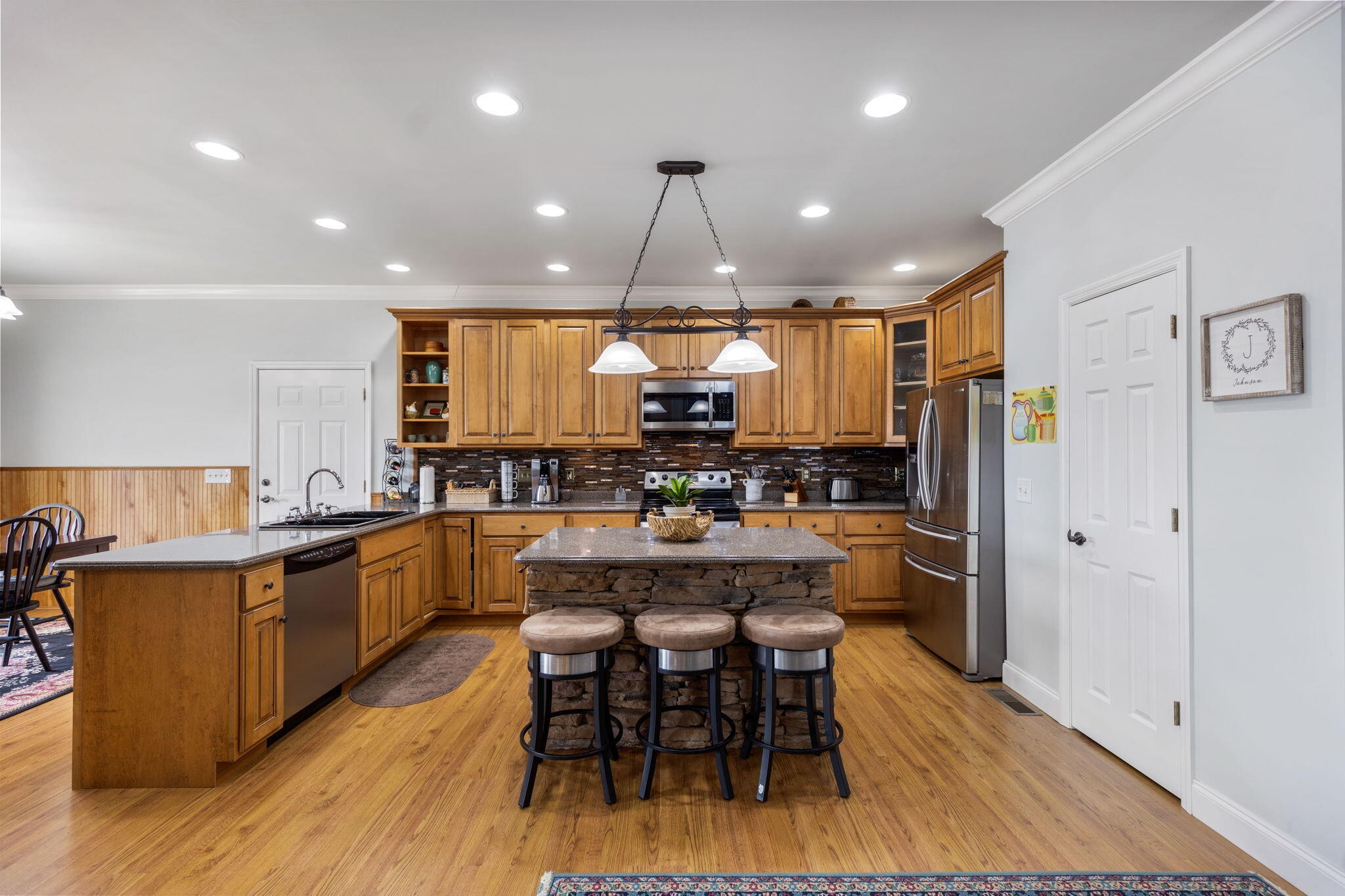 759 Pinhook Road Calhoun, TN 37309 - Photo 12 of 55 a kitchen with stainless steel appliances a dining table chairs and wooden floor