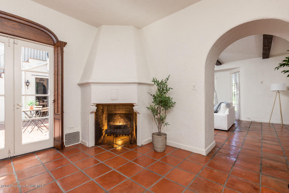 700 South Orange Grove Boulevard Pasadena, CA 91105 - Photo 20 of 50 a view of an empty room with a fireplace and potted plant