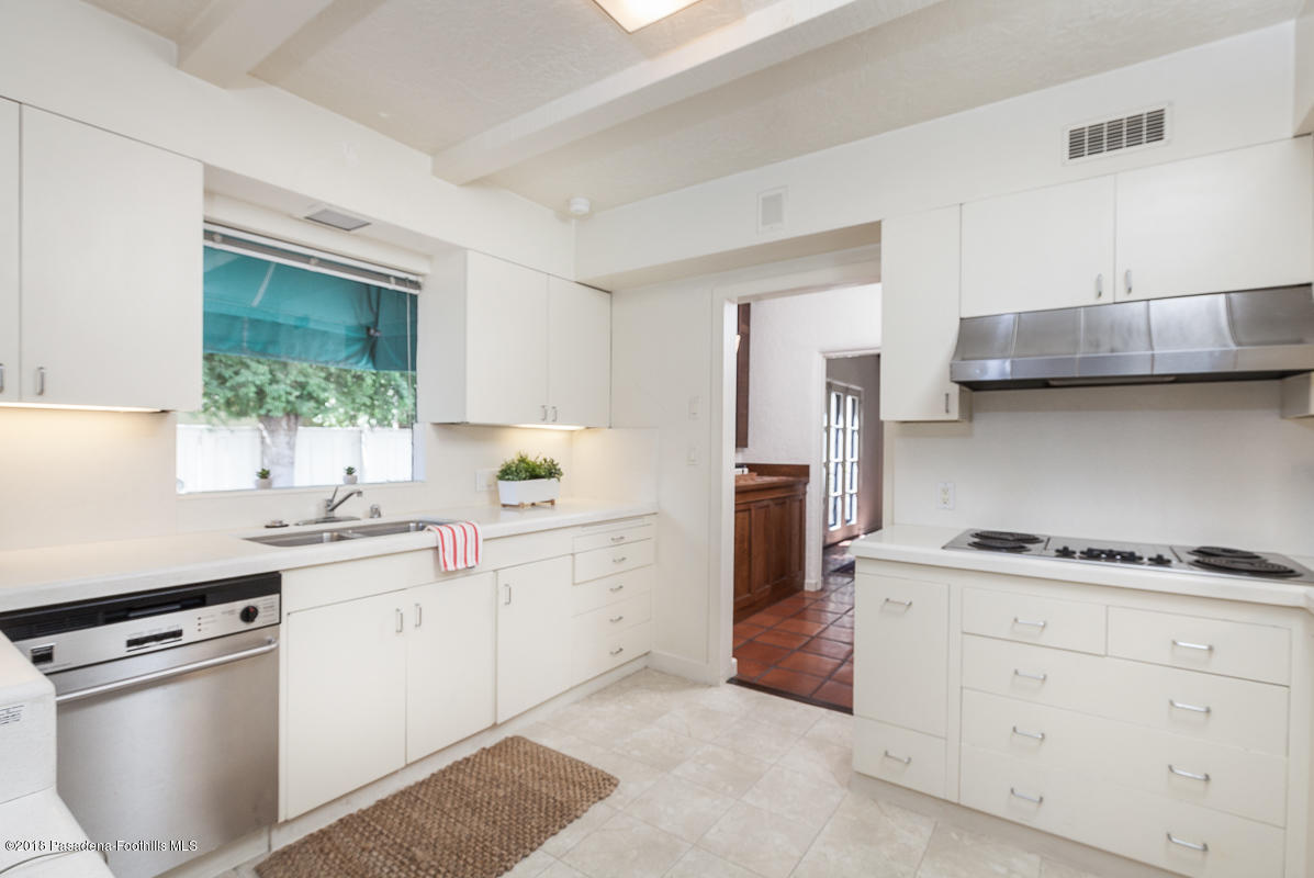 700 South Orange Grove Boulevard Pasadena, CA 91105 - Photo 25 of 50 a kitchen with white cabinets and appliances