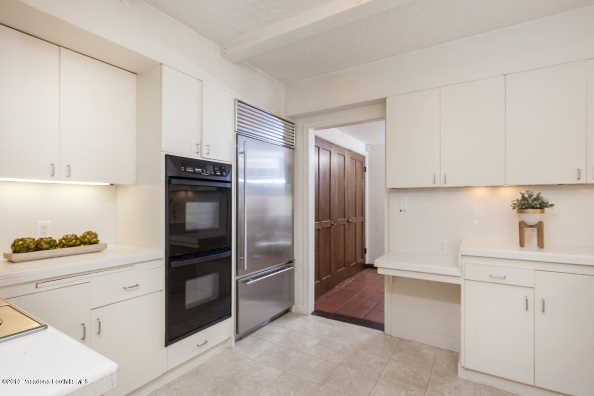 700 South Orange Grove Boulevard Pasadena, CA 91105 - Photo 27 of 50 a kitchen with a refrigerator sink and cabinets