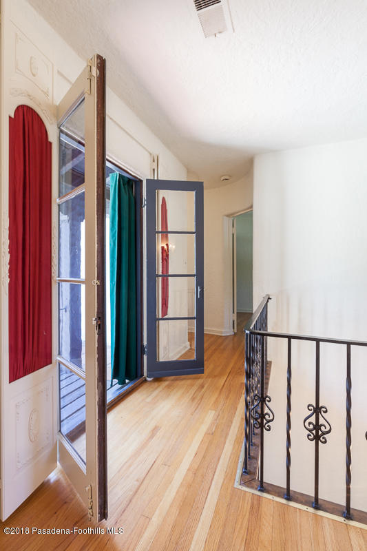 700 South Orange Grove Boulevard Pasadena, CA 91105 - Photo 35 of 50 a view of a room with wooden floor and stairs