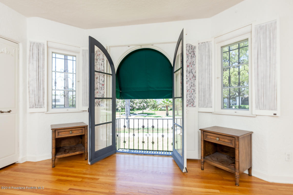 700 South Orange Grove Boulevard Pasadena, CA 91105 - Photo 40 of 50 a living room with a fireplace and wooden floor