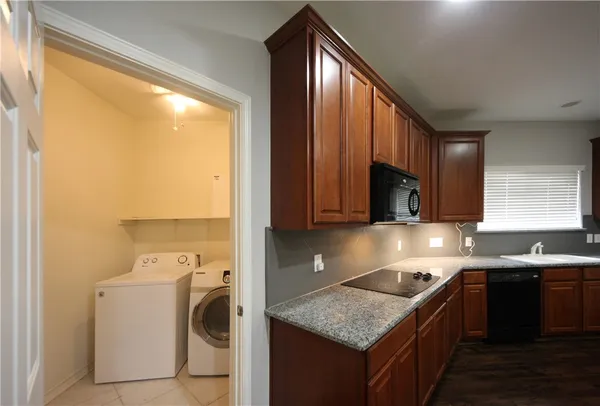 a kitchen that has a sink a stove and a window