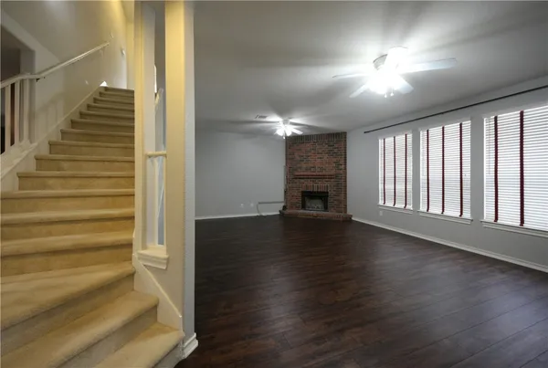 a view of entryway and hall with wooden floor