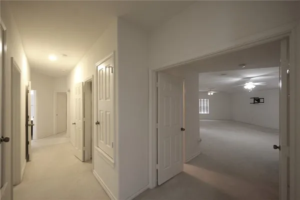 wooden view of a hallway with two rooms