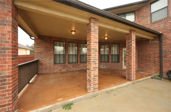 a view of a brick house with a yard
