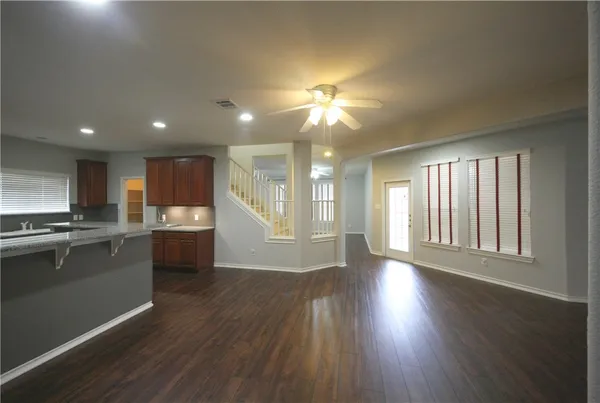 a view of a kitchen with a stove wooden floor and a window