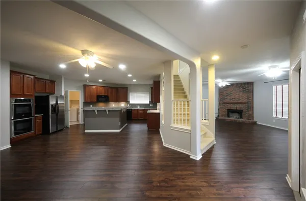 a view of a kitchen with a sink and a stove top oven