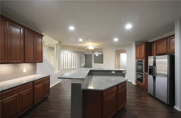a kitchen with stainless steel appliances granite countertop a sink stove and refrigerator