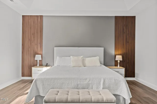 a large bed sitting in a bedroom next to a window