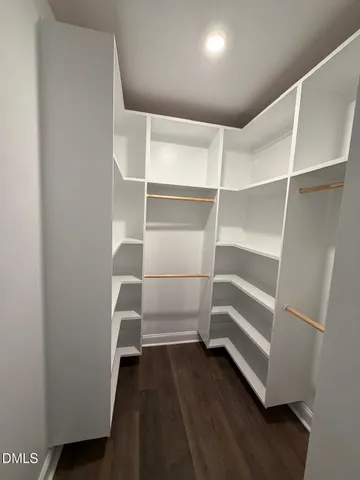 a view of walk in closet with empty racks
