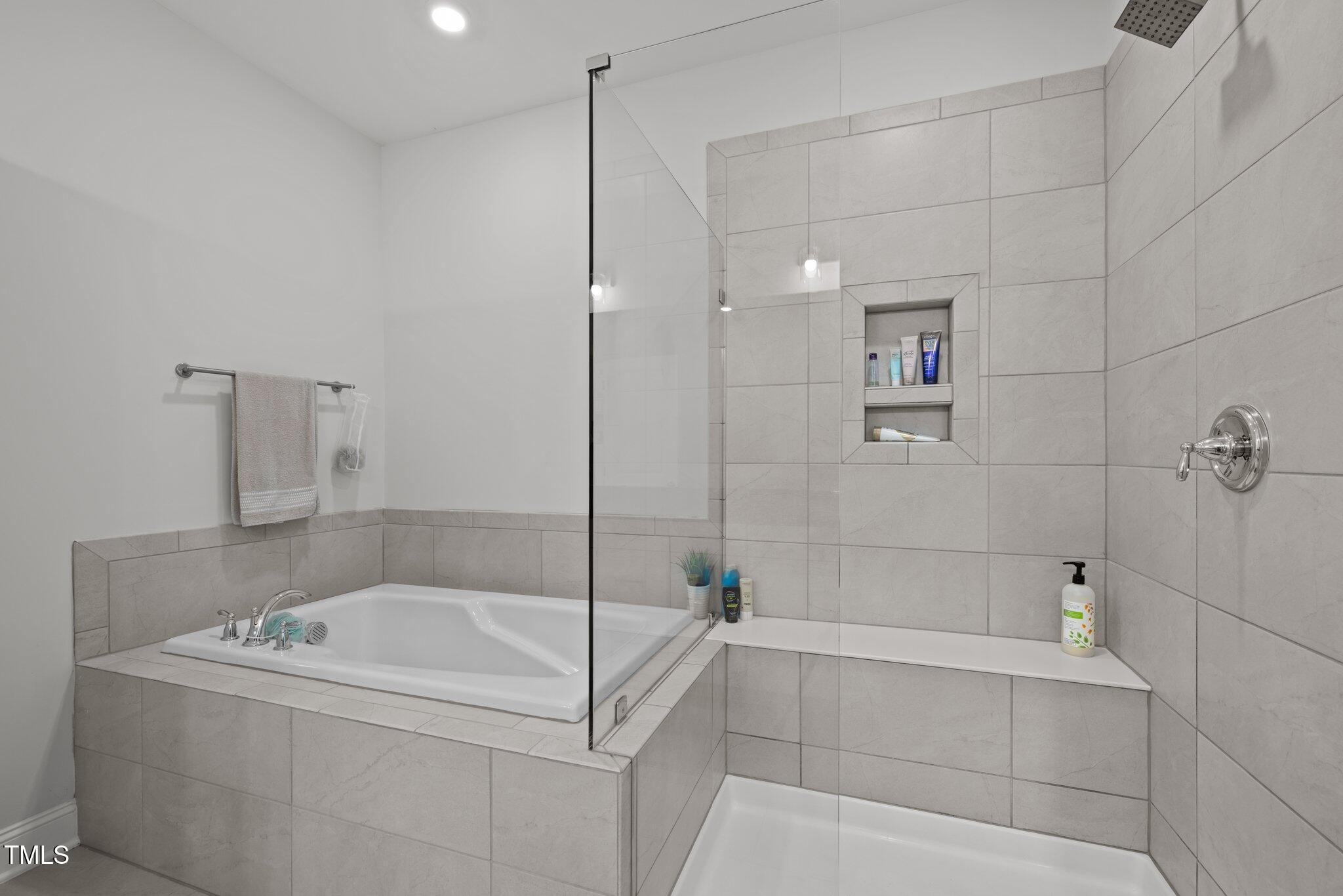 98 Stone Bridge Crossing Chapel Hill, NC 27517 - Photo 16 of 37 a bathroom with a tub a window and a shower