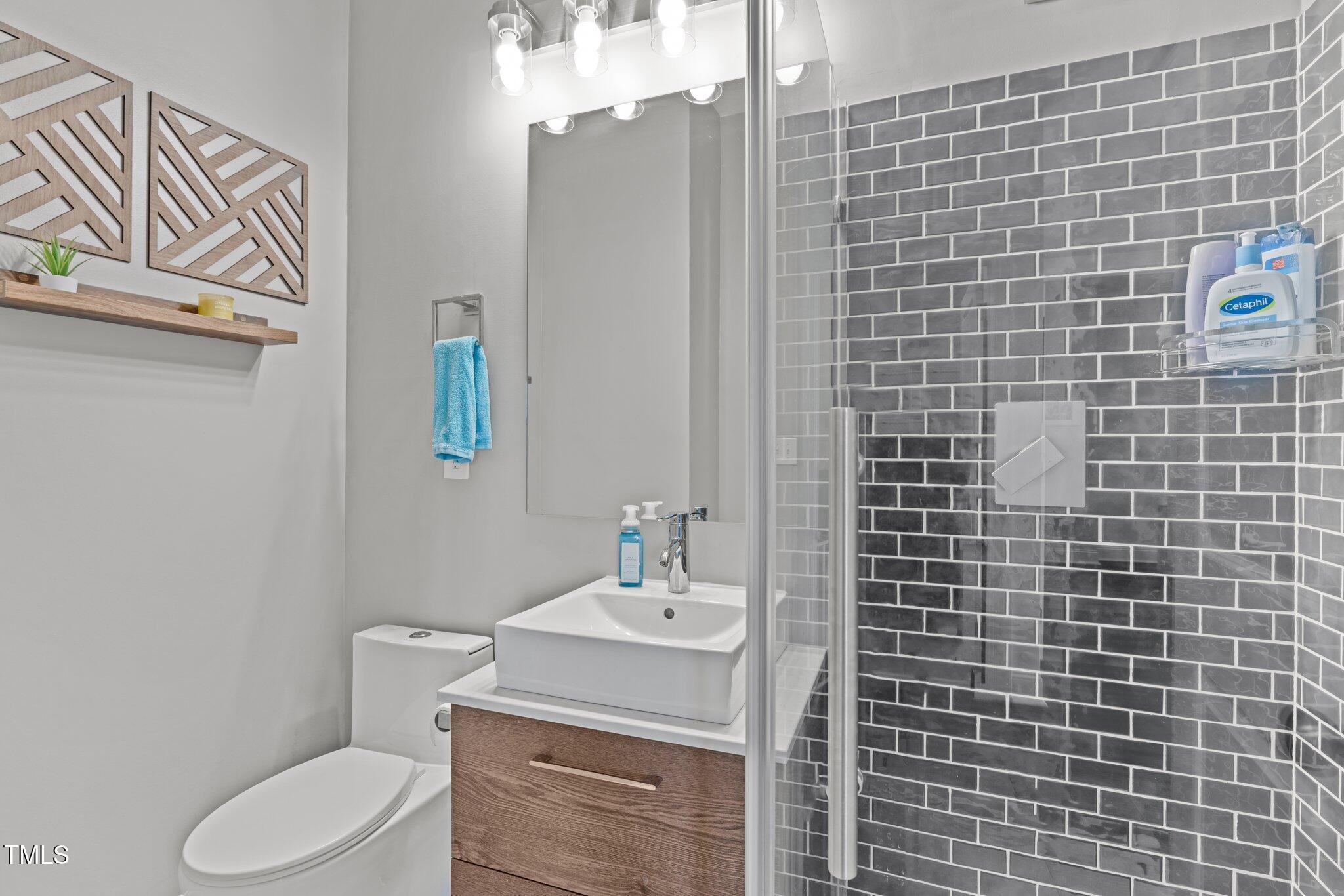 98 Stone Bridge Crossing Chapel Hill, NC 27517 - Photo 18 of 37 a bathroom with a sink a toilet and shower